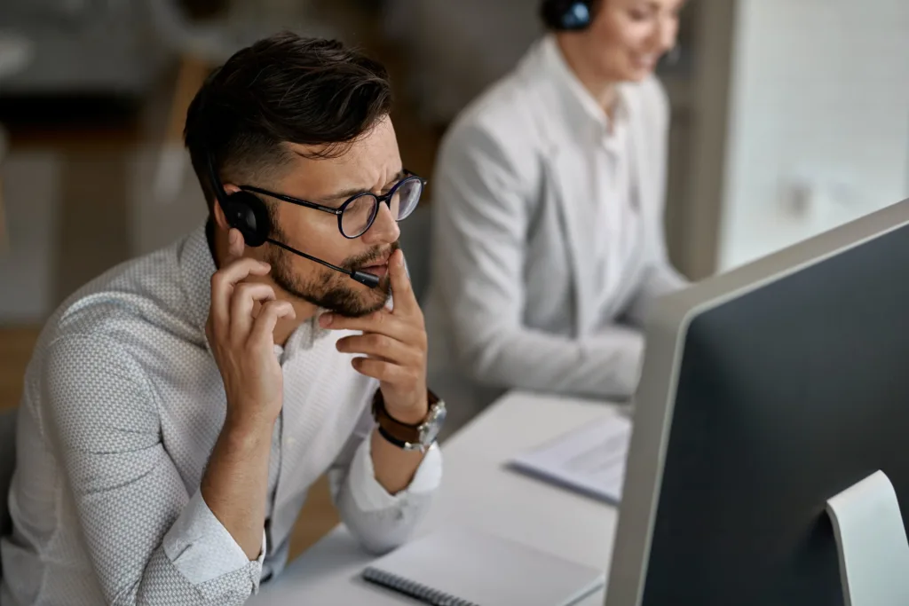 Concentrated Call Center Agent Talking With Customer While Working Office Min